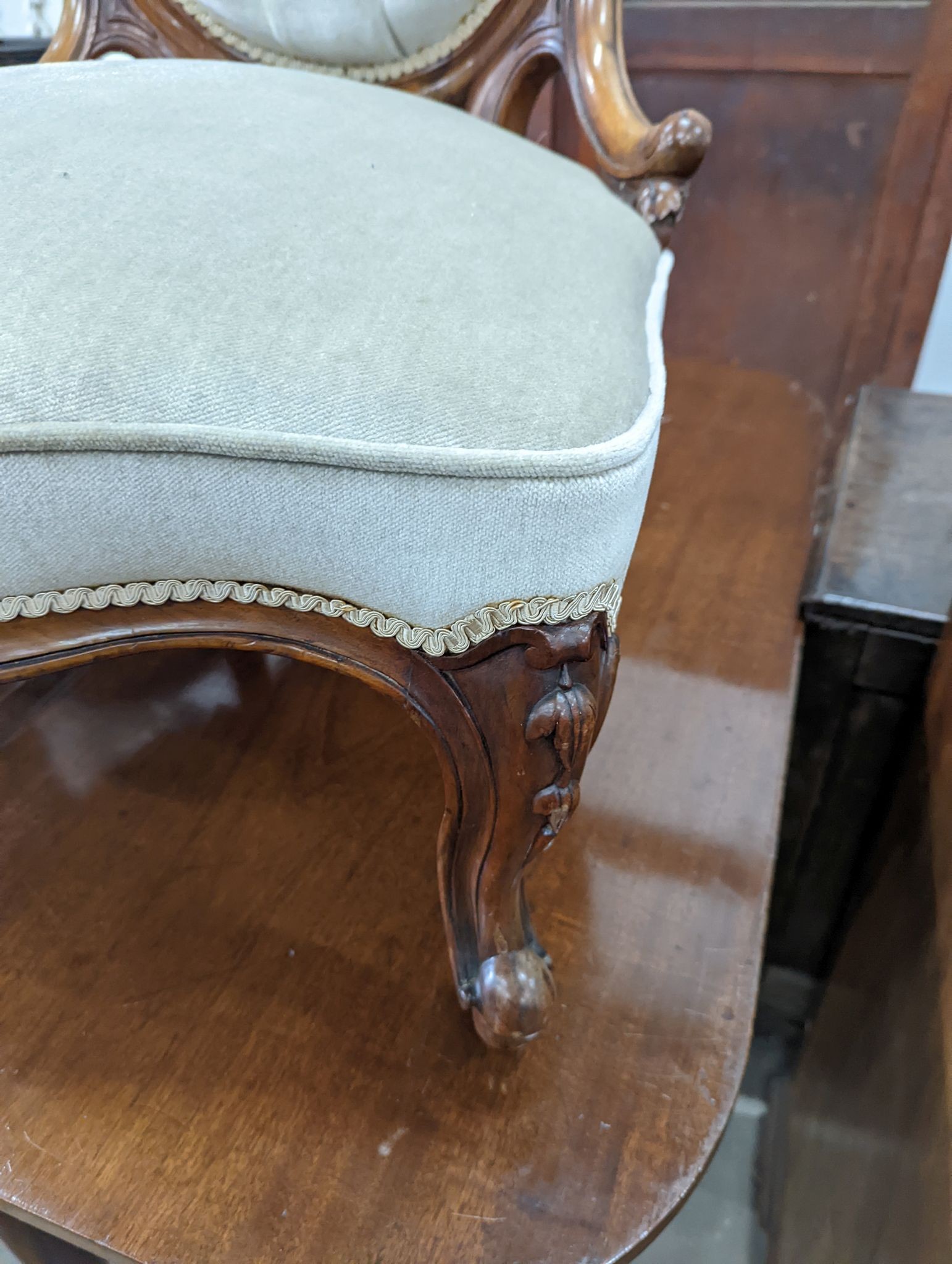 A Victorian walnut upholstered spoonback nursing chair